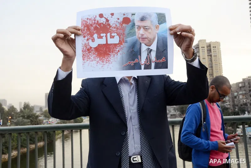 Members of the April 6 movement hold placards during a demonstration of October bridge in Cairo, Egypt on February 14, 2015. Photo by Amr Sayed
