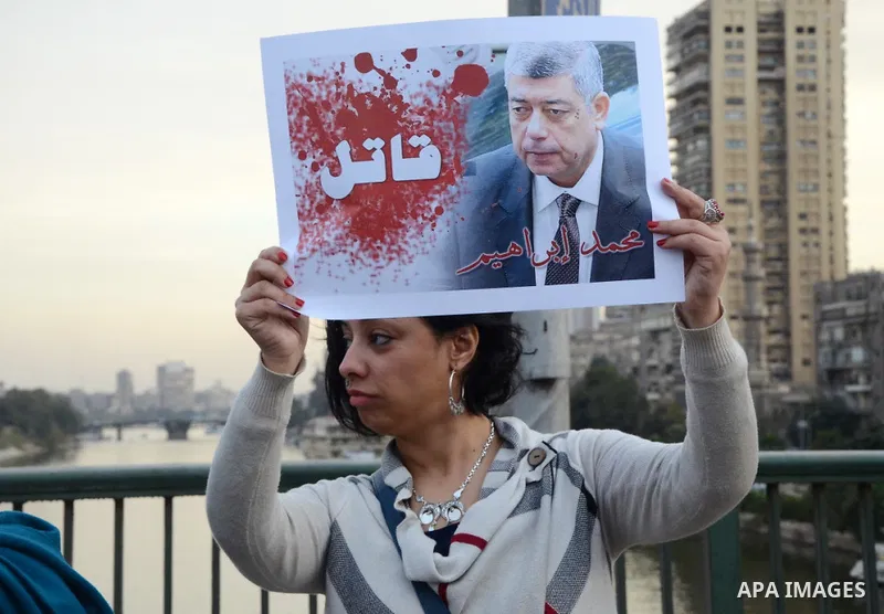 Members of the April 6 movement hold placards during a demonstration of October bridge in Cairo, Egypt on February 14, 2015. Photo by Amr Sayed