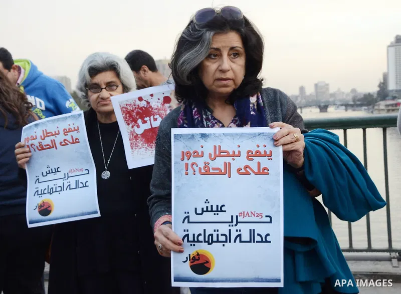 Members of the April 6 movement hold placards during a demonstration of October bridge in Cairo, Egypt on February 14, 2015. Photo by Amr Sayed