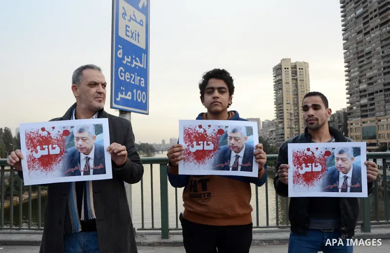 Members of the April 6 movement hold placards during a demonstration of October bridge in Cairo, Egypt on February 14, 2015. Photo by Amr Sayed