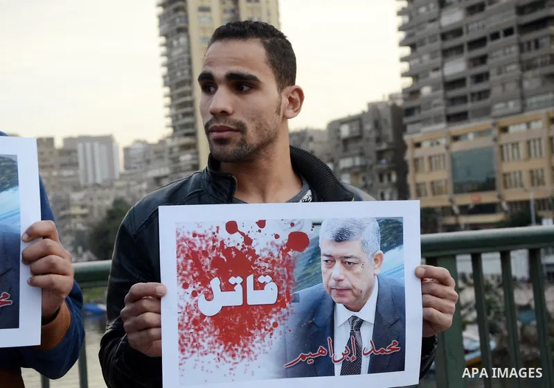 Members of the April 6 movement hold placards during a demonstration of October bridge in Cairo, Egypt on February 14, 2015. Photo by Amr Sayed