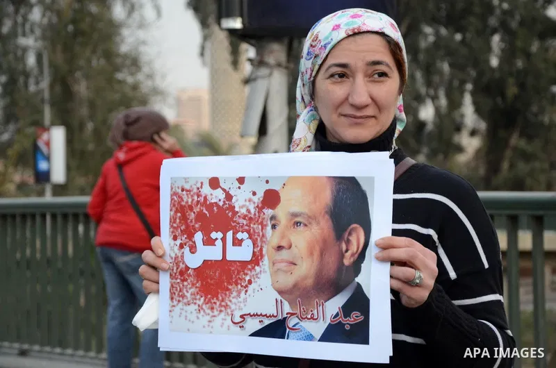 Members of the April 6 movement hold placards during a demonstration of October bridge in Cairo, Egypt on February 14, 2015. Photo by Amr Sayed