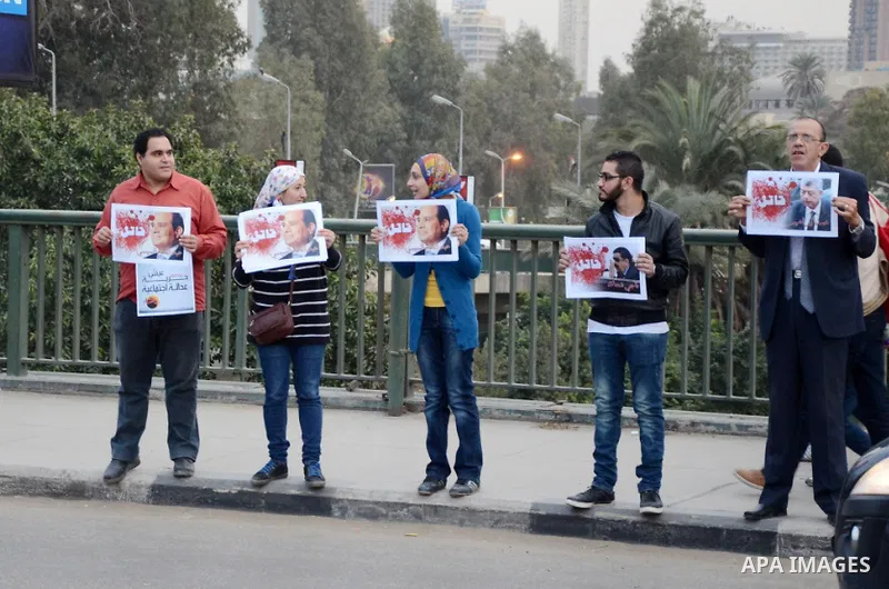 Members of the April 6 movement hold placards during a demonstration of October bridge in Cairo, Egypt on February 14, 2015. Photo by Amr Sayed