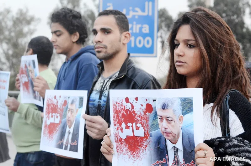 Members of the April 6 movement hold placards during a demonstration of October bridge in Cairo, Egypt on February 14, 2015. Photo by Amr Sayed