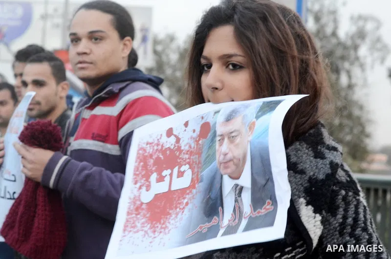Members of the April 6 movement hold placards during a demonstration of October bridge in Cairo, Egypt on February 14, 2015. Photo by Amr Sayed