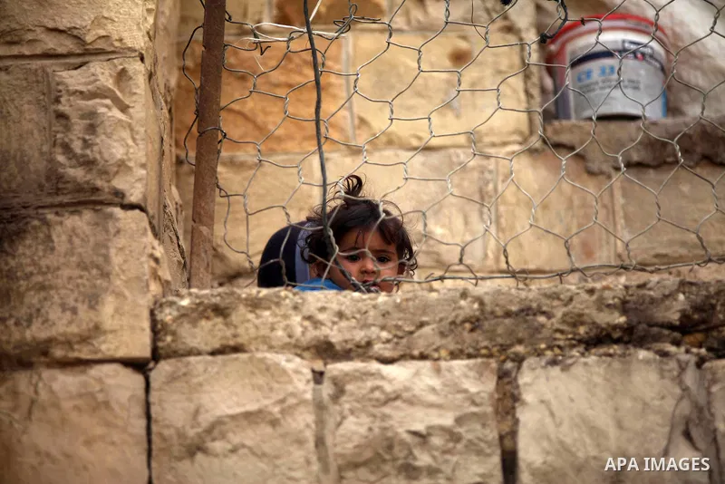 A Palestinian girl poses for a picture inside her family's tent in the West Bank Beduin village of Almaleh, in the northern Jordan Valley February 14, 2015. Photo by Shadi Hatem