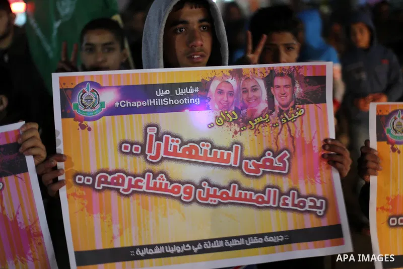 Palestinians take part during a protest to condemn Chapel Hill shooting victims, the three young Muslims who were gunned down in North Carolina this week, in Jabalia in Gaza City, February 14, 2015. Newlywed Deah Shaddy...