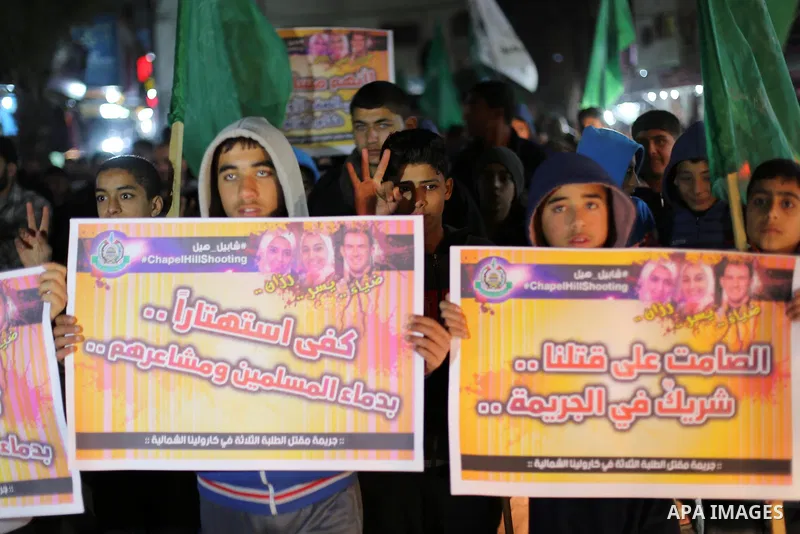 Palestinians take part during a protest to condemn Chapel Hill shooting victims, the three young Muslims who were gunned down in North Carolina this week, in Jabalia in Gaza City, February 14, 2015. Newlywed Deah Shaddy...