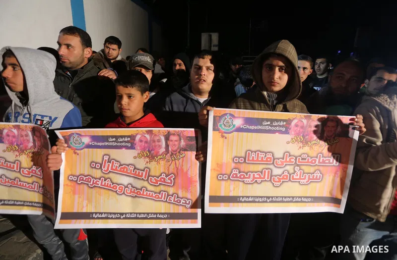 Palestinians take part during a protest to condemn Chapel Hill shooting victims, the three young Muslims who were gunned down in North Carolina this week, in Jabalia in Gaza City, February 14, 2015. Newlywed Deah Shaddy...