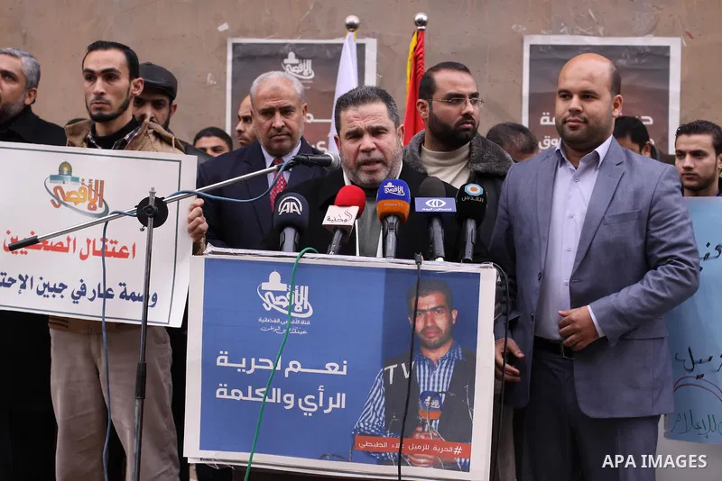 Palestinian journalists hold placards during a protest demanding release of their colleague Alaa al-Titi in Israeli jails, in Gaza city on February 15, 2015. Photo by Mohammed Asad