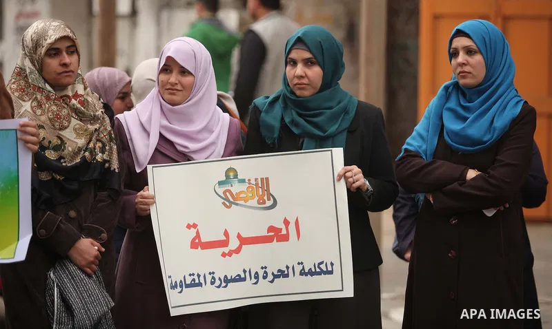 Palestinian journalists hold placards during a protest demanding release of their colleague Alaa al-Titi in Israeli jails, in Gaza city on February 15, 2015. Photo by Ashraf Amra