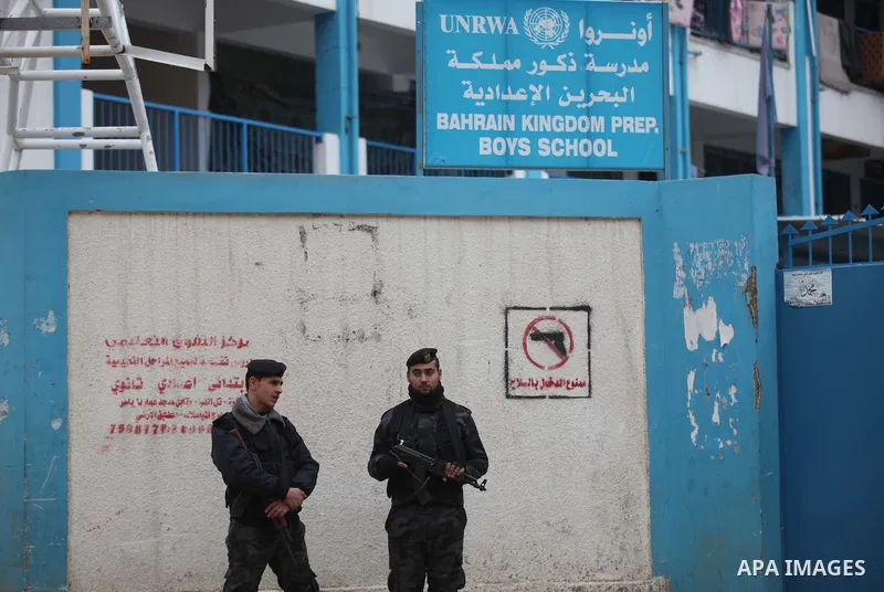 Palestinian policemen stand guard during a visiting of the Quartet Representative to the Middle East and former British Prime Minister, Tony Blair, for a UN-run school sheltering Palestinians, whose houses were destroyed...