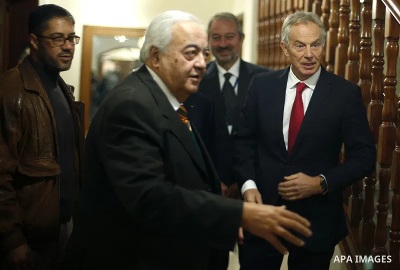 Quartet Representative to the Middle East and former British prime minister Tony Blair stands next to Palestinian Minister of Work Mamoun Abu Shahla during Blair's visit to Gaza City February 15, 2015. APAIMAGES / POOL /...