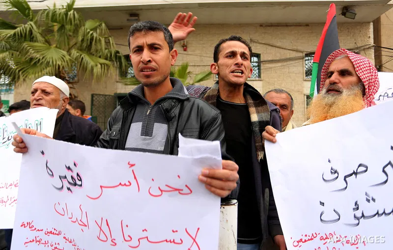 Palestinians with limited-income take part in a demonstration calling the Ministry of social affairs to pay their allocations and providing social assistance, in Rafah in the southern Gaza Strip, February 15, 2015. The P...