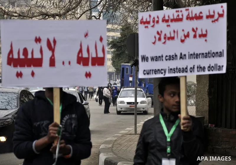 Egyptian supporters of the Wafd Party take part during a protest to condemn Chapel Hill shooting victims, the three young Muslims who were gunned down in North Carolina this week, in front of American Embassy, in Cairo F...