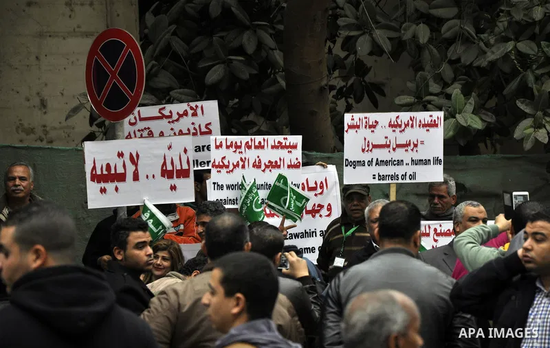 Egyptian supporters of the Wafd Party take part during a protest to condemn Chapel Hill shooting victims, the three young Muslims who were gunned down in North Carolina this week, in front of American Embassy, in Cairo F...