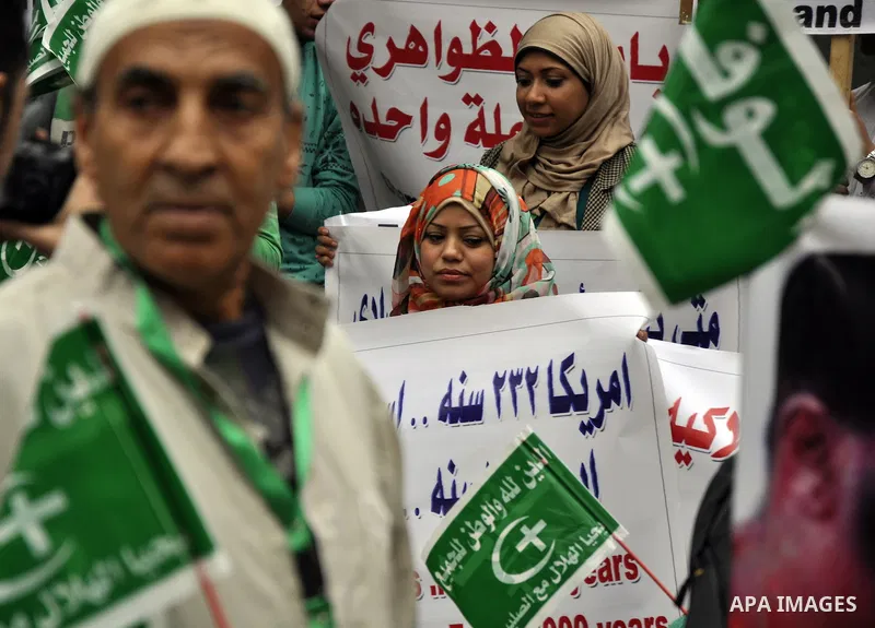 Egyptian supporters of the Wafd Party take part during a protest to condemn Chapel Hill shooting victims, the three young Muslims who were gunned down in North Carolina this week, in front of American Embassy, in Cairo F...