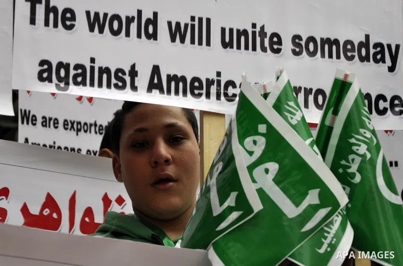 Egyptian supporters of the Wafd Party take part during a protest to condemn Chapel Hill shooting victims, the three young Muslims who were gunned down in North Carolina this week, in front of American Embassy, in Cairo F...