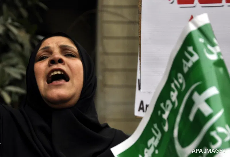 Egyptian supporters of the Wafd Party take part during a protest to condemn Chapel Hill shooting victims, the three young Muslims who were gunned down in North Carolina this week, in front of American Embassy, in Cairo F...