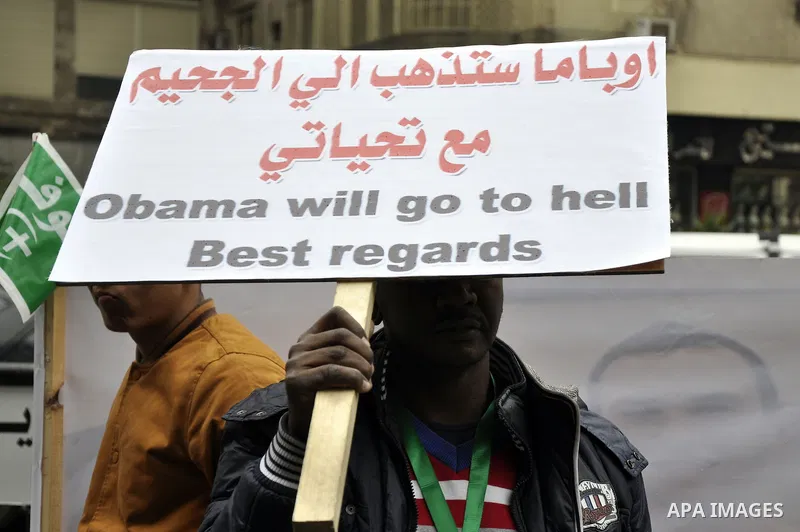 Egyptian supporters of the Wafd Party take part during a protest to condemn Chapel Hill shooting victims, the three young Muslims who were gunned down in North Carolina this week, in front of American Embassy, in Cairo F...