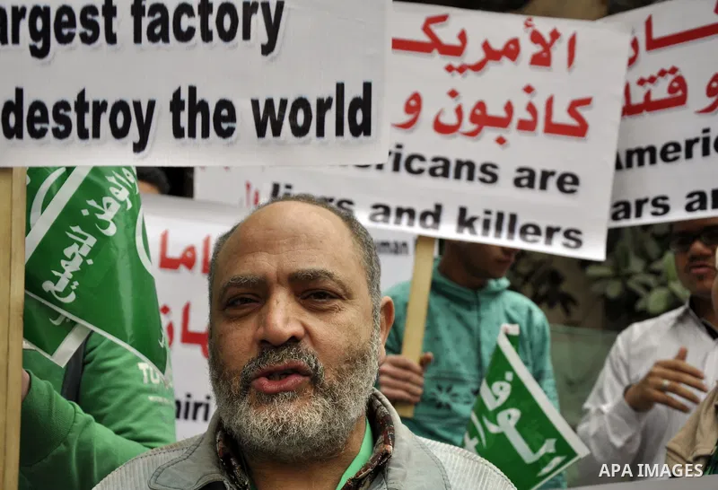 Egyptian supporters of the Wafd Party take part during a protest to condemn Chapel Hill shooting victims, the three young Muslims who were gunned down in North Carolina this week, in front of American Embassy, in Cairo F...