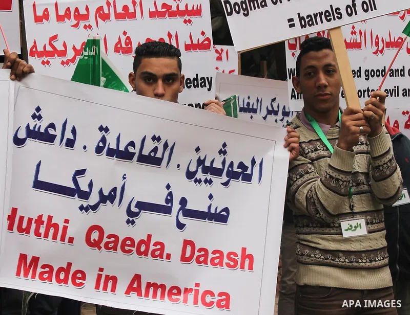 Egyptian supporters of the Wafd Party take part during a protest to condemn Chapel Hill shooting victims, the three young Muslims who were gunned down in North Carolina this week, in front of American Embassy, in Cairo F...