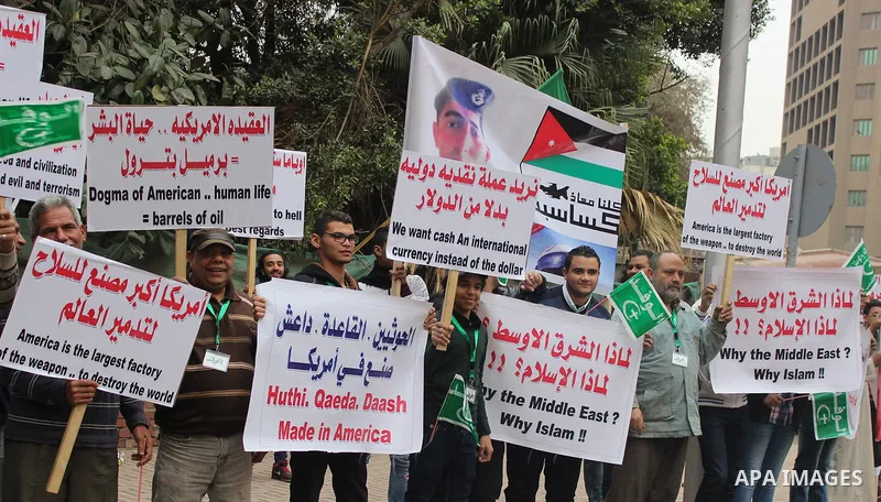 Egyptian supporters of the Wafd Party take part during a protest to condemn Chapel Hill shooting victims, the three young Muslims who were gunned down in North Carolina this week, in front of American Embassy, in Cairo F...