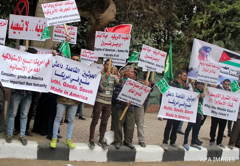 Egyptian supporters of the Wafd Party take part during a protest to condemn Chapel Hill shooting victims, the three young Muslims who were gunned down in North Carolina this week, in front of American Embassy, in Cairo F...