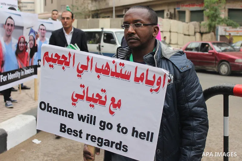 Egyptian supporters of the Wafd Party take part during a protest to condemn Chapel Hill shooting victims, the three young Muslims who were gunned down in North Carolina this week, in front of American Embassy, in Cairo F...