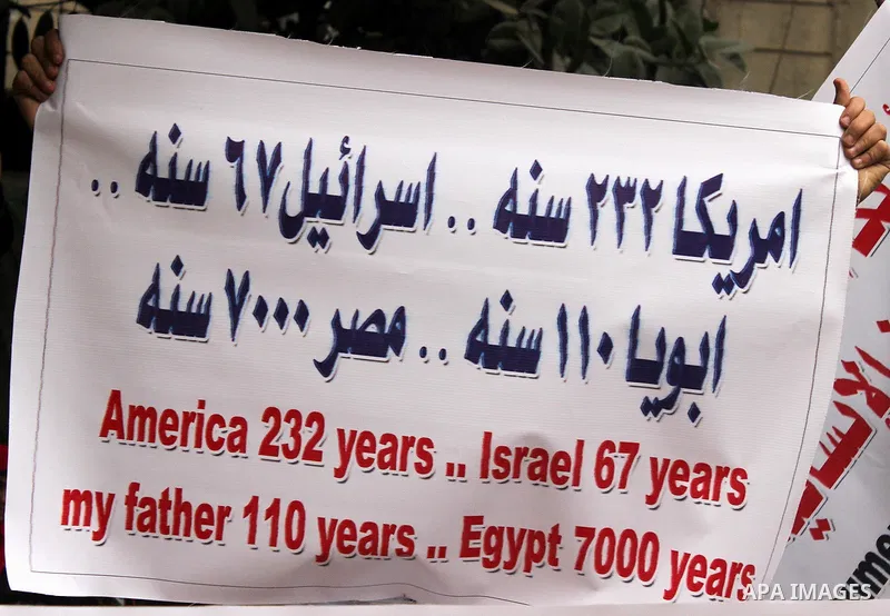 Egyptian supporters of the Wafd Party take part during a protest to condemn Chapel Hill shooting victims, the three young Muslims who were gunned down in North Carolina this week, in front of American Embassy, in Cairo F...