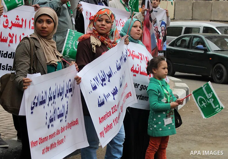 Egyptian supporters of the Wafd Party take part during a protest to condemn Chapel Hill shooting victims, the three young Muslims who were gunned down in North Carolina this week, in front of American Embassy, in Cairo F...