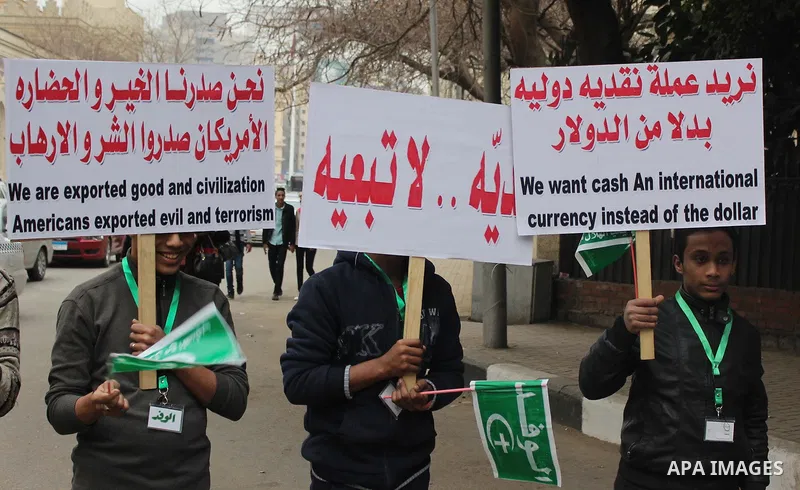 Egyptian supporters of the Wafd Party take part during a protest to condemn Chapel Hill shooting victims, the three young Muslims who were gunned down in North Carolina this week, in front of American Embassy, in Cairo F...