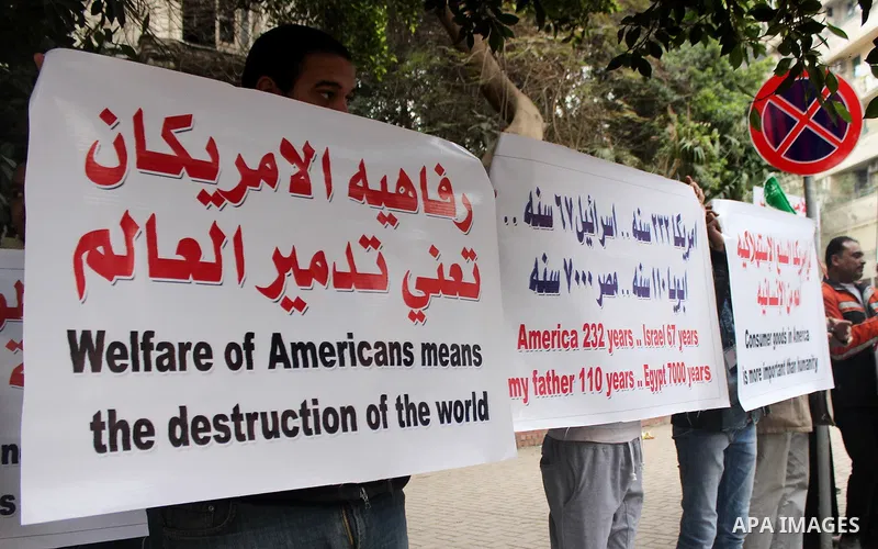 Egyptian supporters of the Wafd Party take part during a protest to condemn Chapel Hill shooting victims, the three young Muslims who were gunned down in North Carolina this week, in front of American Embassy, in Cairo F...