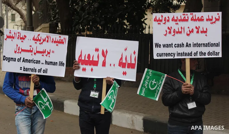 Egyptian supporters of the Wafd Party take part during a protest to condemn Chapel Hill shooting victims, the three young Muslims who were gunned down in North Carolina this week, in front of American Embassy, in Cairo F...
