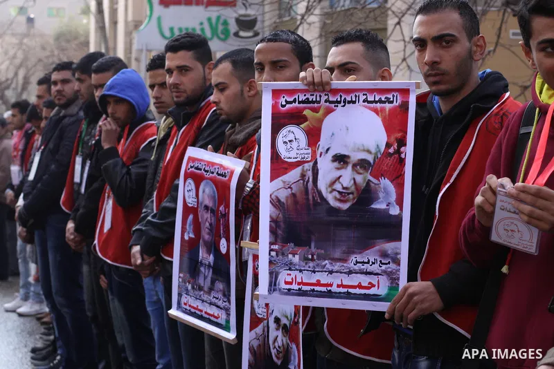Palestinians take part a protest demanding the release of their relatives prisoners held in Israeli jails, in front of the Red Cross office in Gaza City, on February 16, 2015. Photo by Mohammed Asad