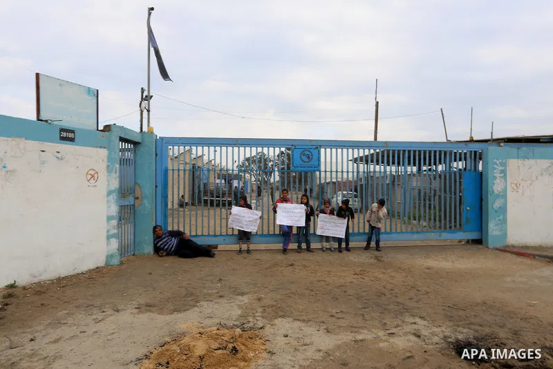 Palestinians take part in a protest calling for reconstruction of houses that witnesses said were destroyed by Israeli shelling during a 50-day war last summer, outside a United Nations food distribution center in Rafah...