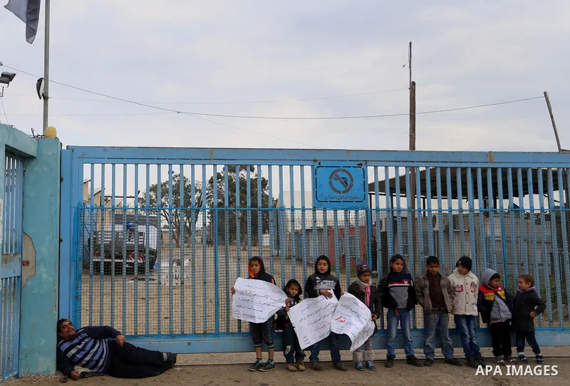 Palestinians take part in a protest calling for reconstruction of houses that witnesses said were destroyed by Israeli shelling during a 50-day war last summer, outside a United Nations food distribution center in Rafah...