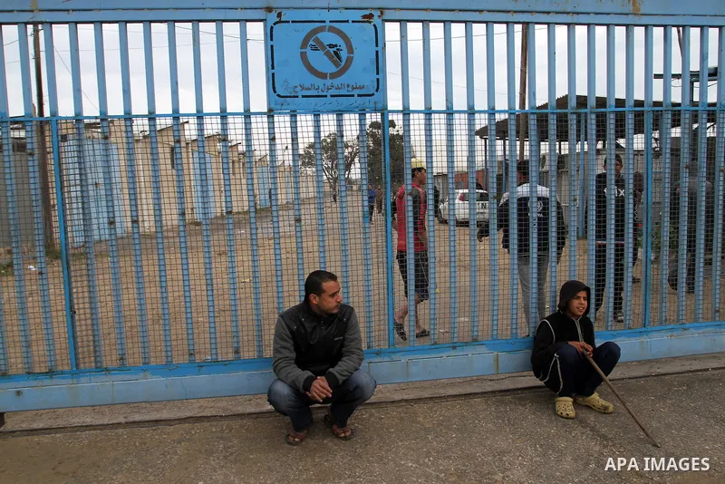 Palestinians take part in a protest calling for reconstruction of houses that witnesses said were destroyed by Israeli shelling during a 50-day war last summer, outside a United Nations food distribution center in Rafah...