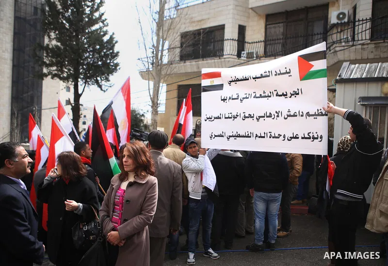 Palestinians take part in a protest against the murders of the Twenty-one Egyptians beheaded in Libya by the Islamic State (IS), in the West Bank city of Ramallah, on February 16, 2015. Islamic State released the video o...