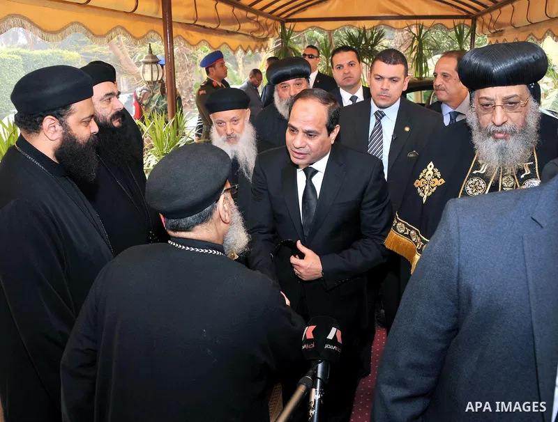 A handout photo made available by the Egyptian Presidency shows Egyptian President Abdel Fattah al-Sisi meeting with Pope Tawadros II of Alexandria, head of the Egyptian Coptic Orthodox Church, to offer condolences after...
