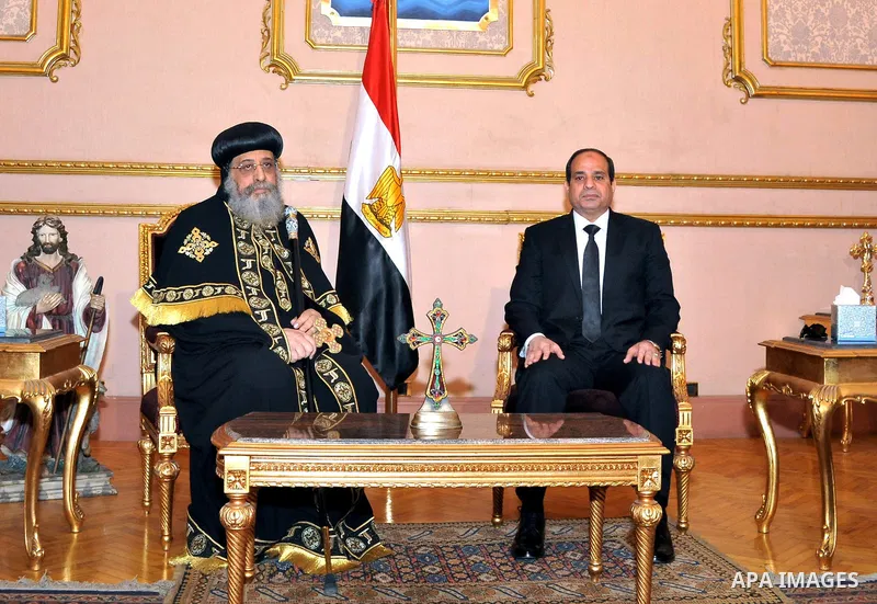 A handout photo made available by the Egyptian Presidency shows Egyptian President Abdel Fattah al-Sisi (R) meeting with Pope Tawadros II (L) of Alexandria, head of the Egyptian Coptic Orthodox Church, to offer condolenc...