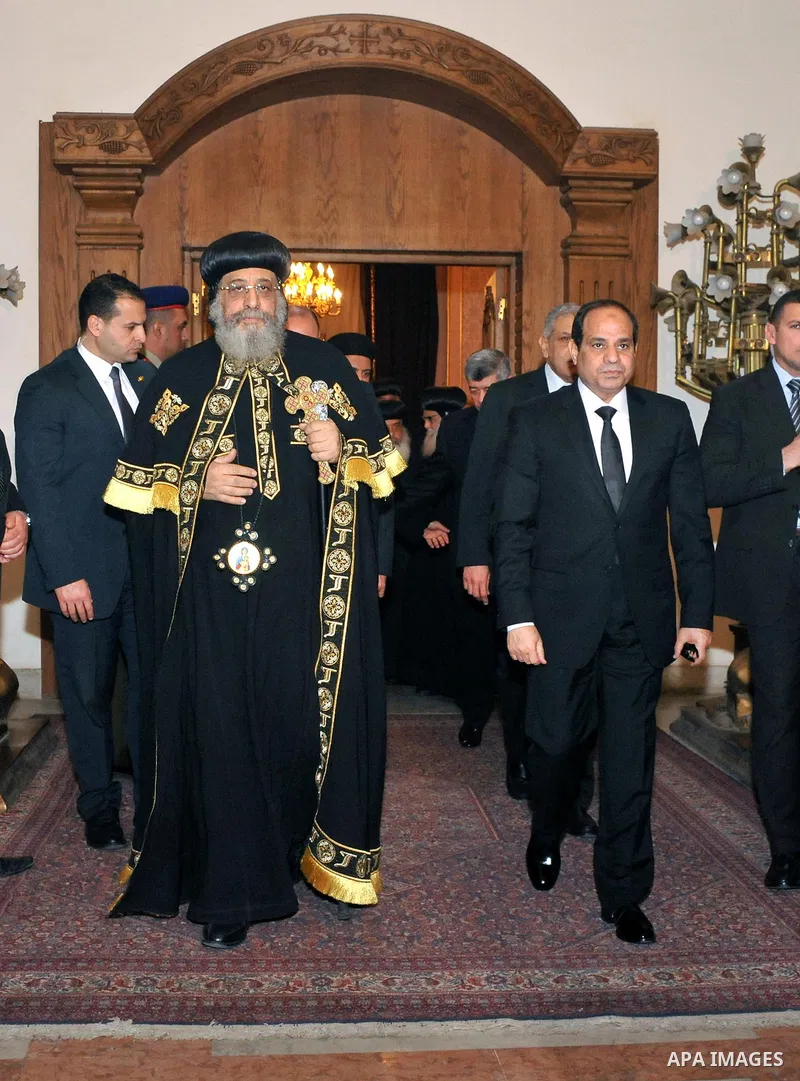 A handout photo made available by the Egyptian Presidency shows Egyptian President Abdel Fattah al-Sisi meeting with Pope Tawadros II of Alexandria, head of the Egyptian Coptic Orthodox Church, to offer condolences after...