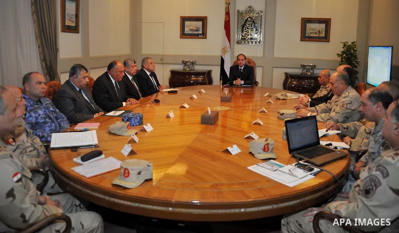 A handout photo made available by the Egyptian Presidency shows Egyptian President Abdel Fattah al-Sisi (C), speaking during an urgent meeting with National Defense Council at the presidential palace in Cairo, Egypt, 16...