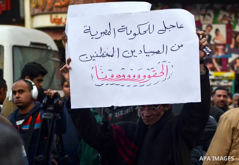 An Egyptian man holds a placard during a demonstration to denounce the killing of Egyptian Christians in Libya, in Cairo,16 February 2015. An Islamic State video released on 15 February claimed to show the extremist grou...