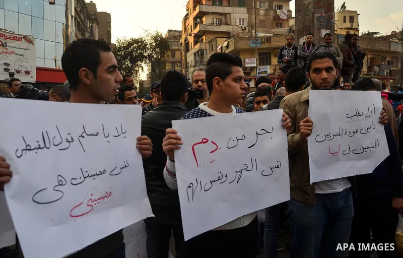 Egyptian youths hold placards during a demonstration to denounce the killing of Egyptian Christians in Libya, in Cairo,16 February 2015. An Islamic State video released on 15 February claimed to show the extremist group...