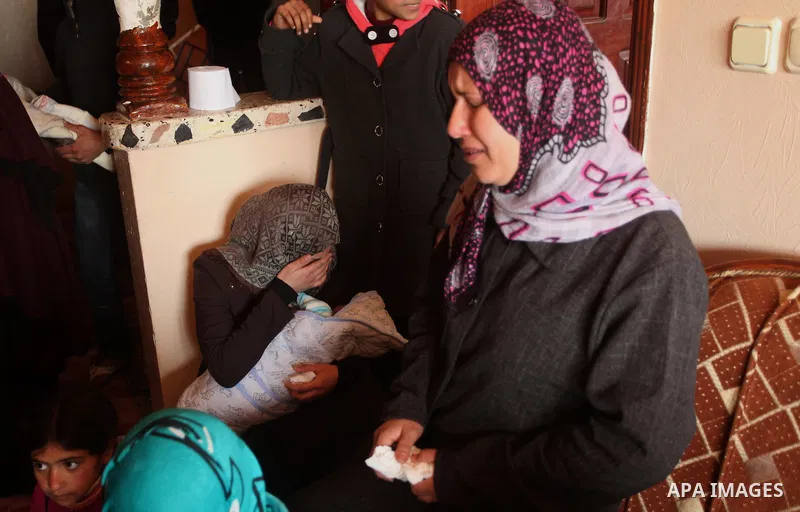 Relatives of Palestinian boy Izz eldeen Al-Kafarana, 9 months old, mourn during his funeral in Biet Hanoun in the northern Gaza Strip February 17, 2015. Palestinian health officials said Al-Kafarana died when fire erupte...