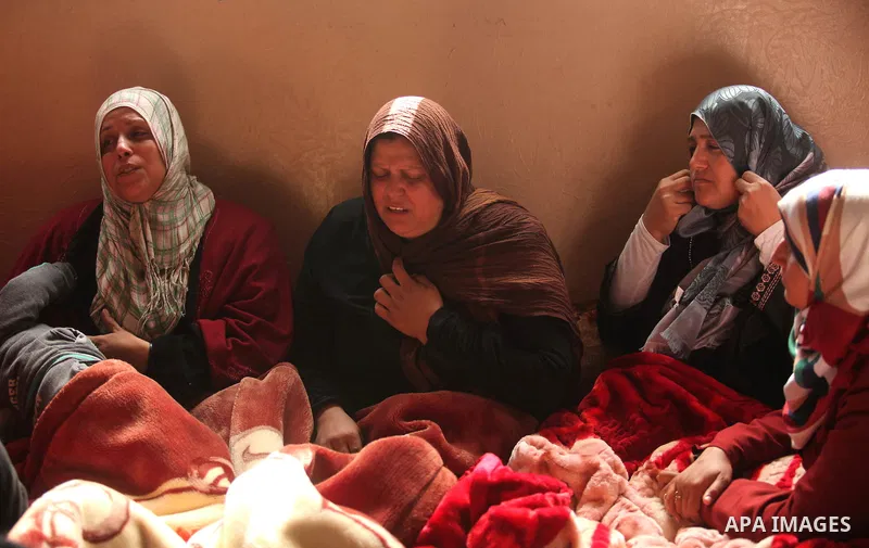 Mother (C) of Palestinian boy Izz eldeen Al-Kafarana, 9 months old, mourns during his funeral in Biet Hanoun in the northern Gaza Strip, February 17, 2015. According to Palestinian health officials, Al-Kafarana died when...
