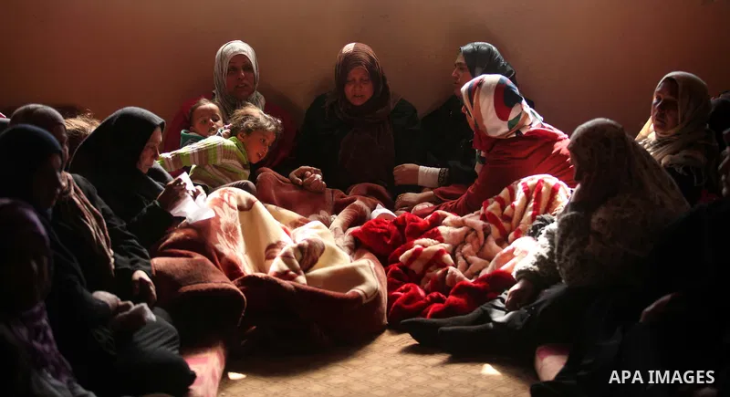 Mother (C) of Palestinian boy Izz eldeen Al-Kafarana, 9 months old, mourns during his funeral in Biet Hanoun in the northern Gaza Strip, February 17, 2015. According to Palestinian health officials, Al-Kafarana died when...