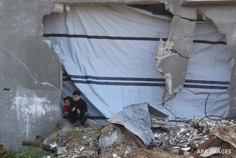 Palestinian children play outside thier family's house, which was damaged during the recent Israeli war, in Shejaiya neighborhood in Gaza city, February 17, 2015. At least 100,000 Palestinians are still living without ad...