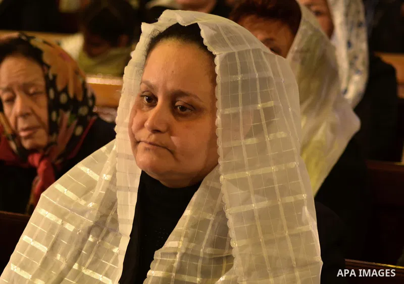 An Egyptian Coptic woman attends a mass led by Egypt's Coptic Pope Tawadros II to honor the memory of the Egyptian Coptic Christians murdered by Islamic State (IS) group militants in Libya, at Saint-Mark's Coptic Cathedr...